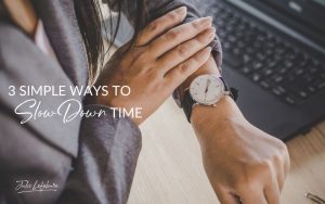 3 Simple Ways to Slow Down Time | woman's hand pulling back gray suit sleeve of other hand to see her wristwatch