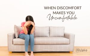 When Discomfort Makes You Uncomfortable | woman sitting on couch with head hid in hands