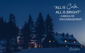 "All Is Calm, All Is Bright" - Carols of Encouragement | log cabin on a hill with lights in windows against trees and a dark winter sky