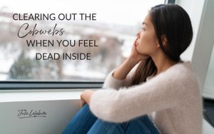 Clearing Out the Cobwebs When You Feel Dead Inside | woman wearing an ivory sweater, sitting looking out window